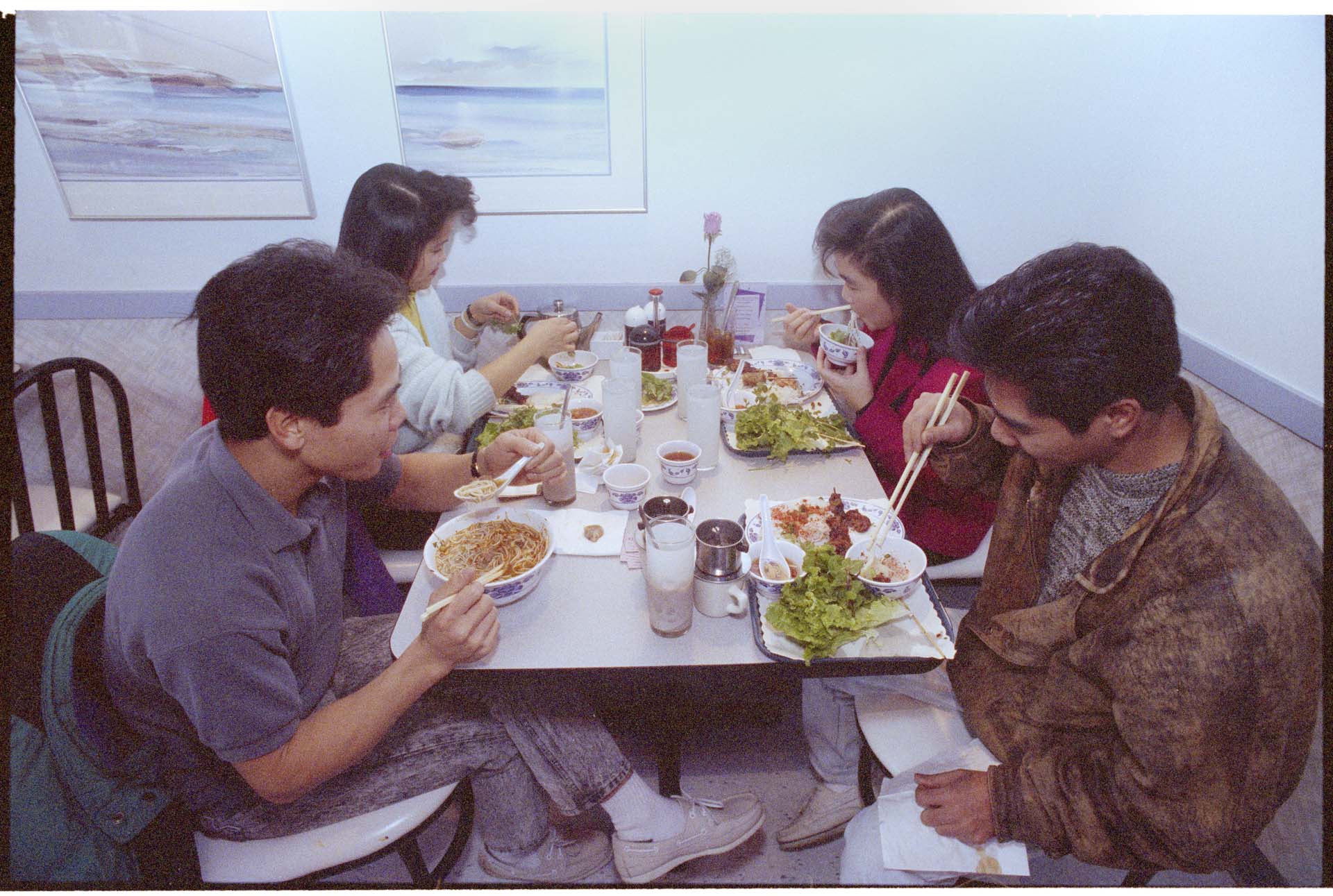 Image of Four people eating at a restaurant in Little Saigon, Seattle, January 14, 1993