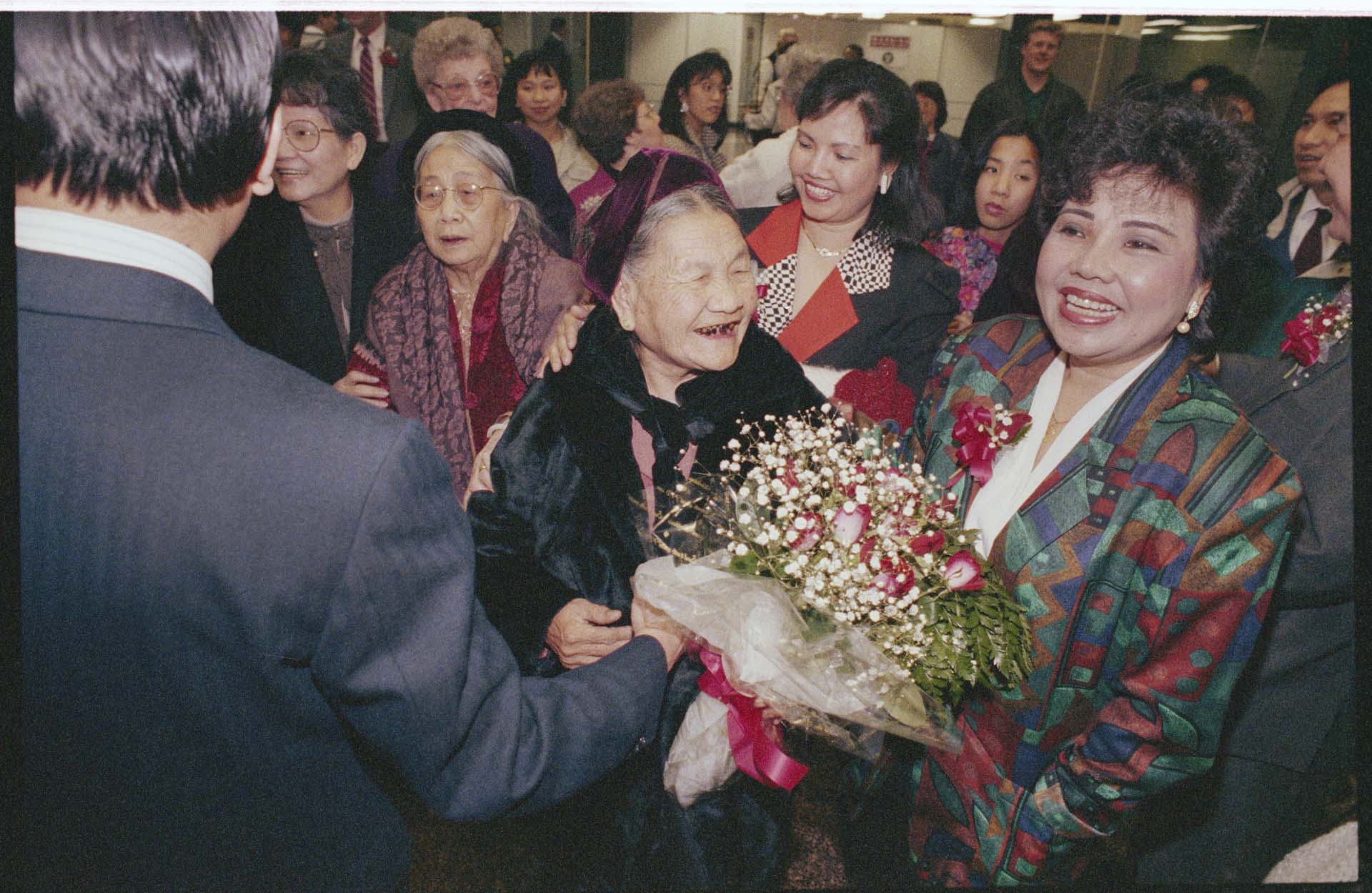 Image of An Tran surrounded by family and friends at Sea-Tac Airport, February 23, 1993