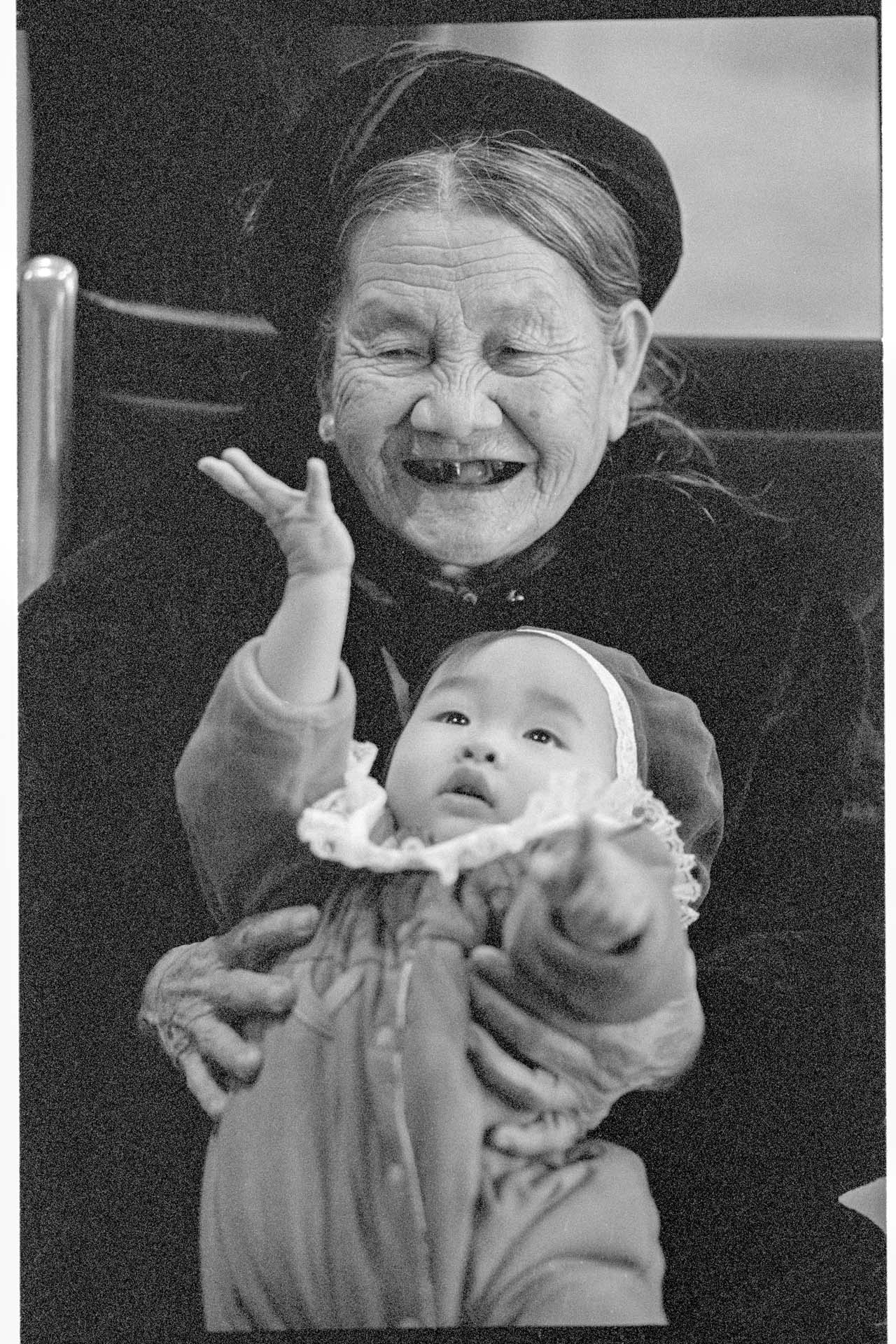 Image of An Tran holding baby during reunion at SeaTac airport, February 23, 1993