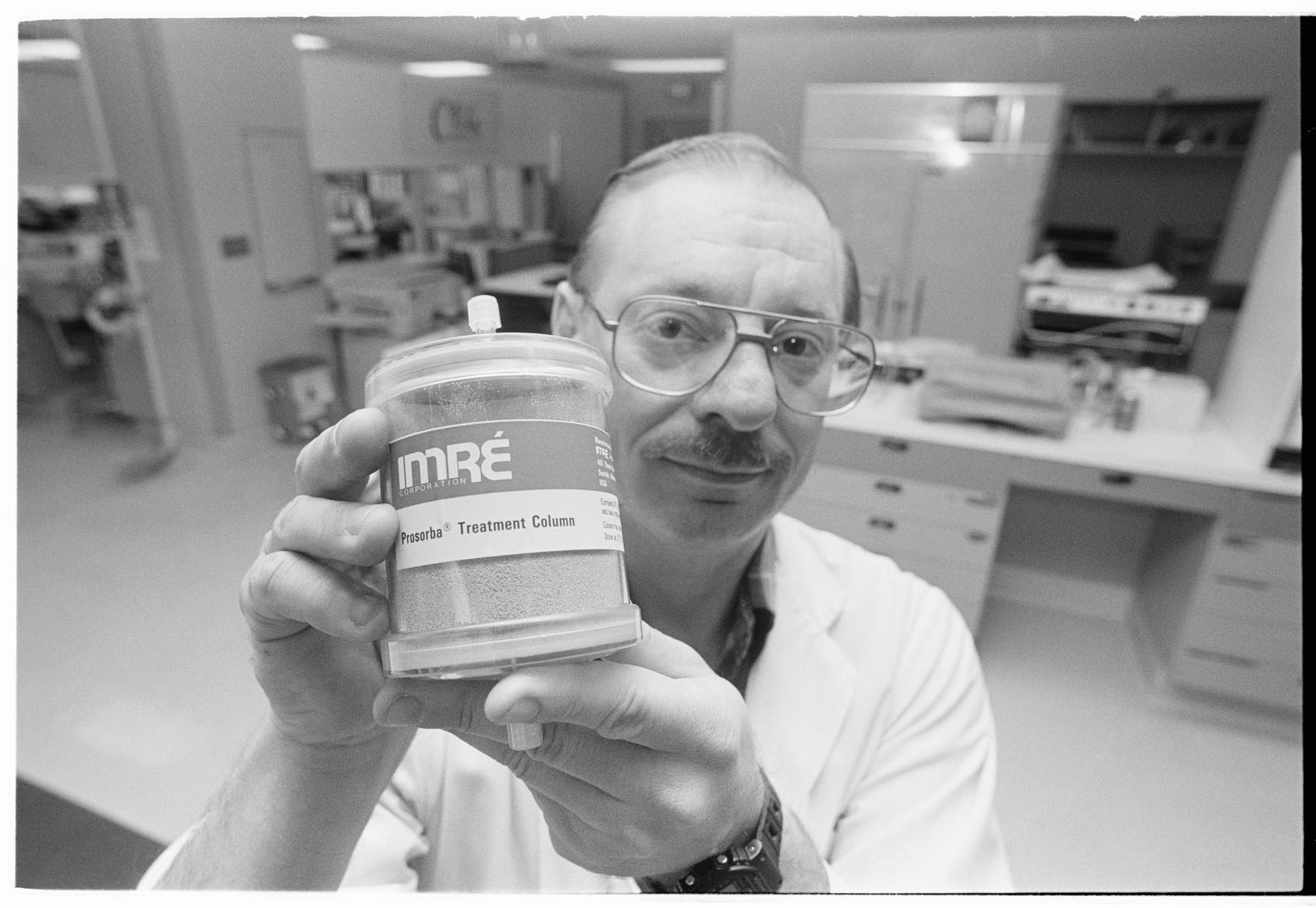 Image of Joseph P. Balint Jr. holding Prosorba Column device at IMRE Corp., Seattle,  March 22, 1993