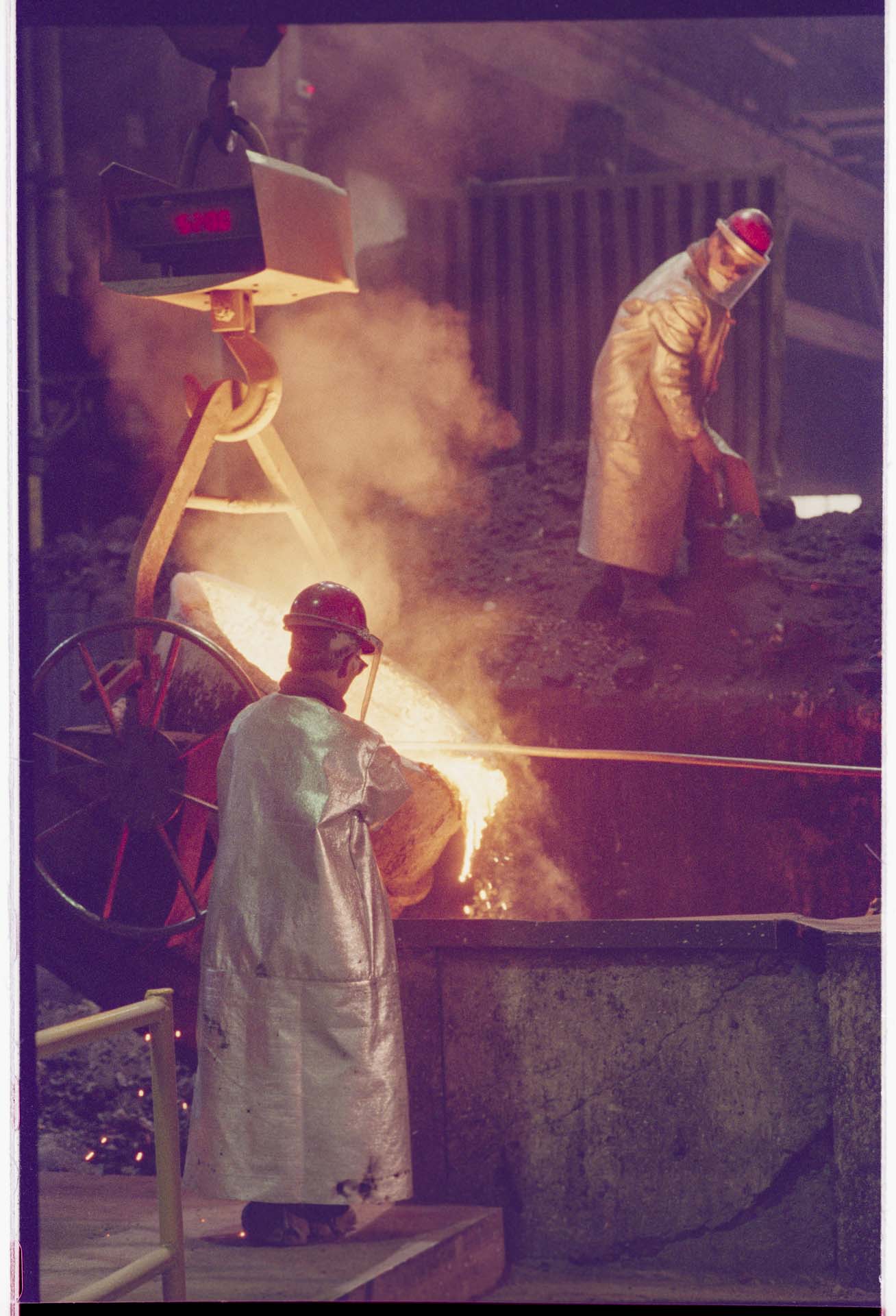 Image of Foundry workers pouring metal from crucible, Seattle, June 16, 1993