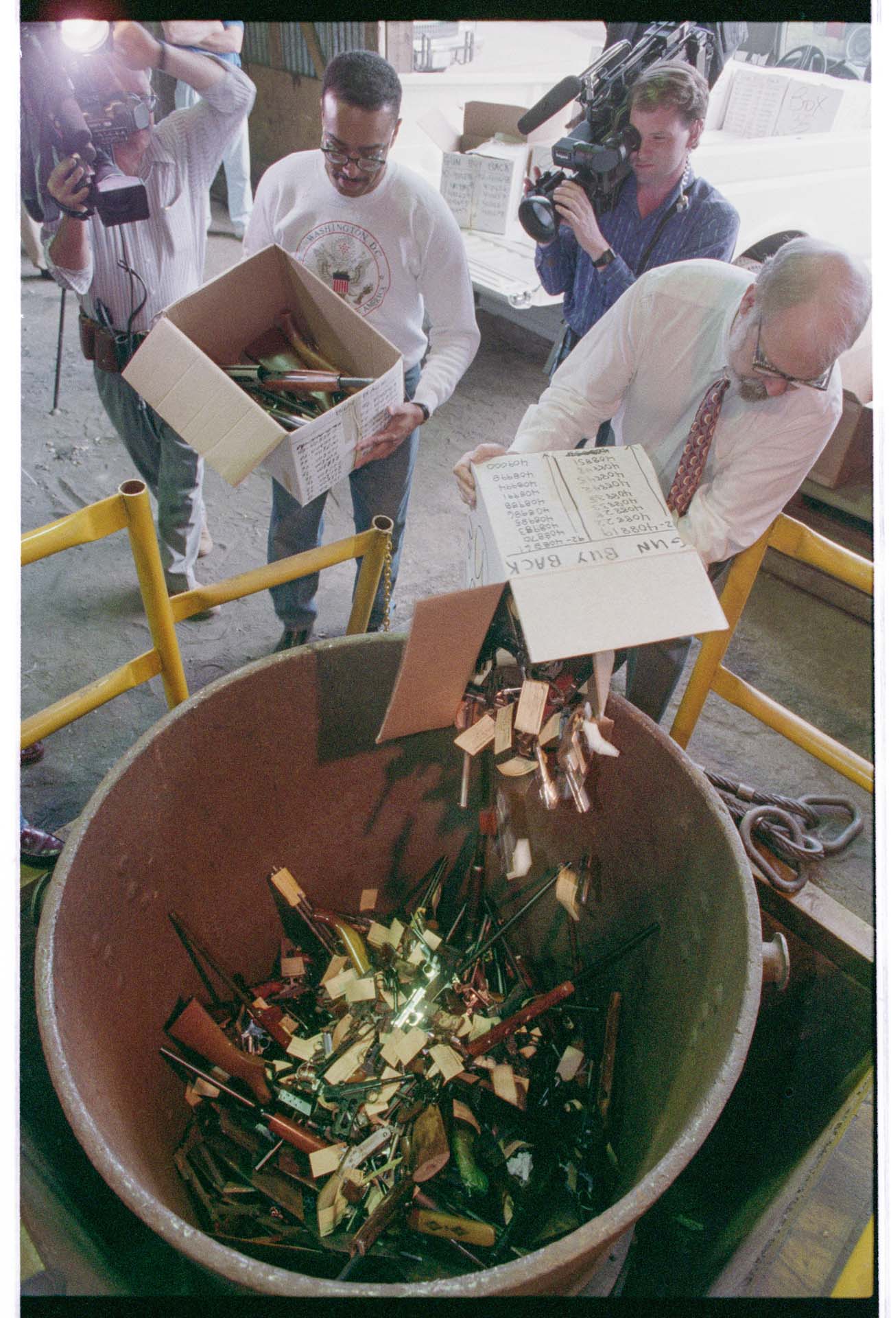 Image of Stop the Violence members putting guns into a foundry crucible, Seattle, June 16, 1993
