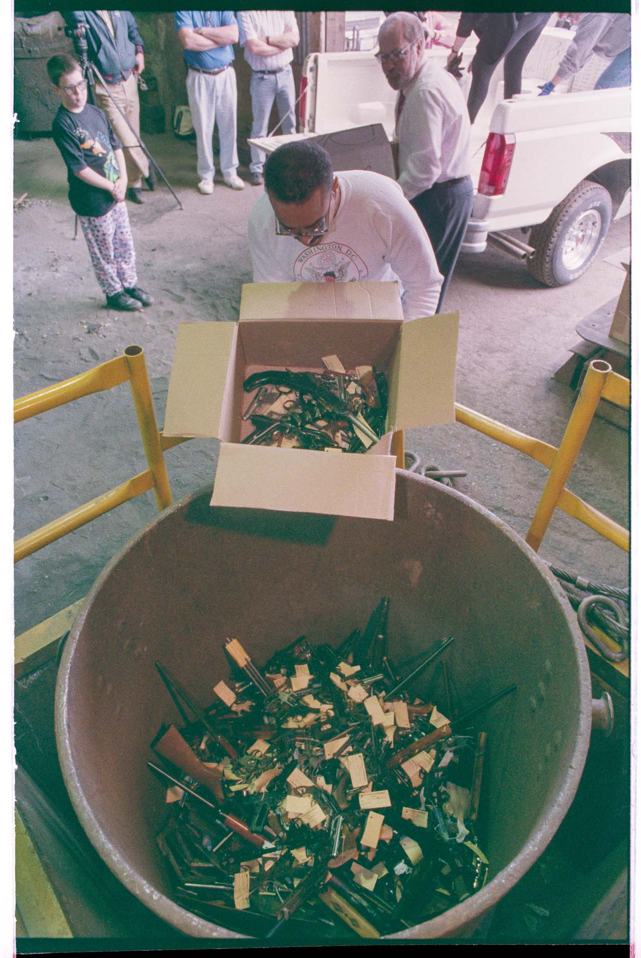 Image of Man unloading guns into foundry crucible, Seattle, June 16, 1993