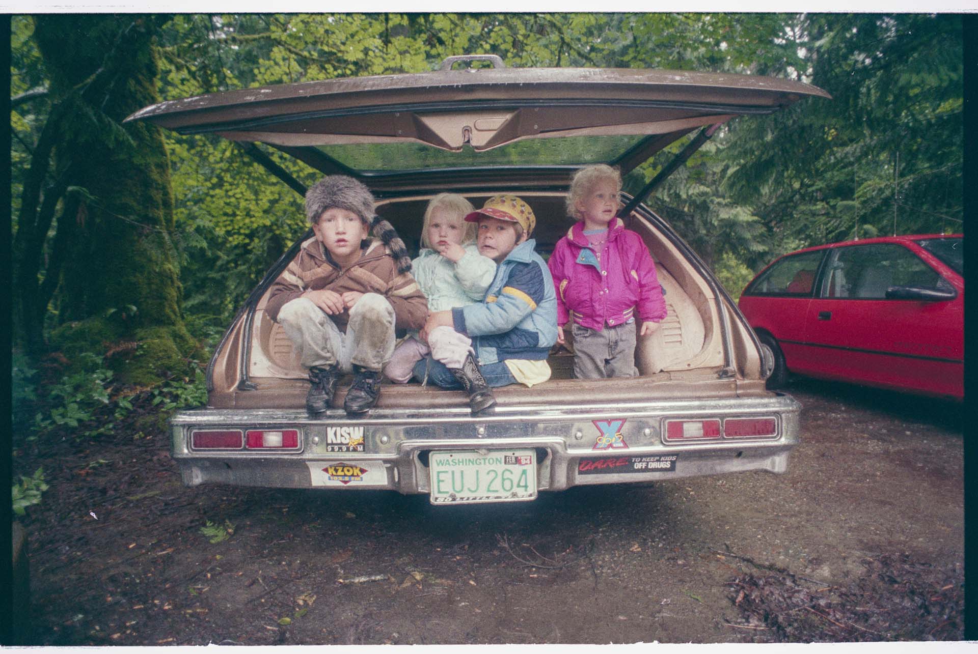 Image of Children sheltering from rain at campground, June 22, 1993