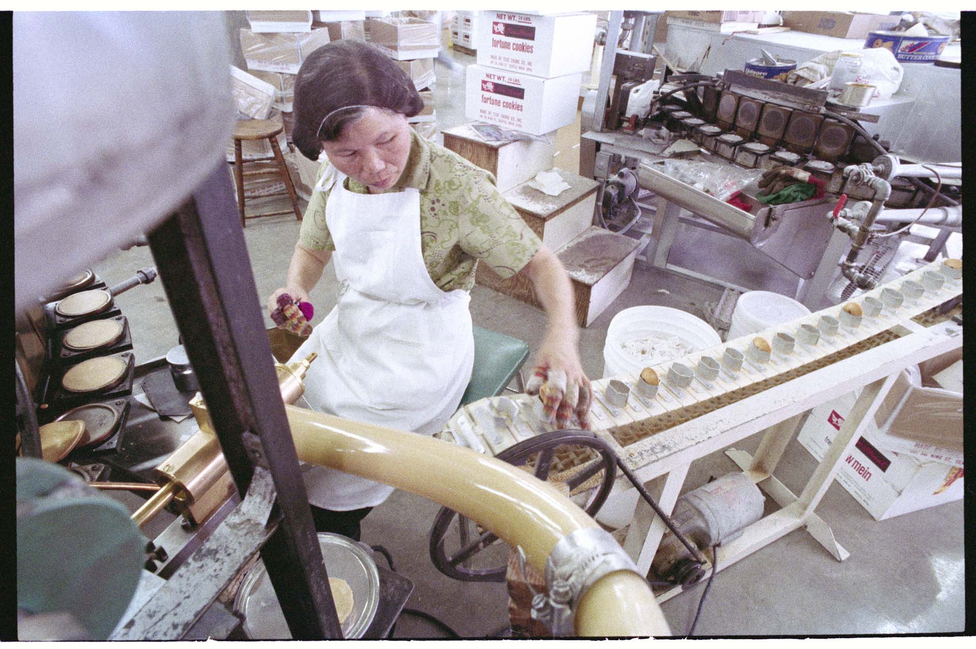 Image of Woman making fortune cookies at Tsue Chong Co., Seattle, July 16, 1993