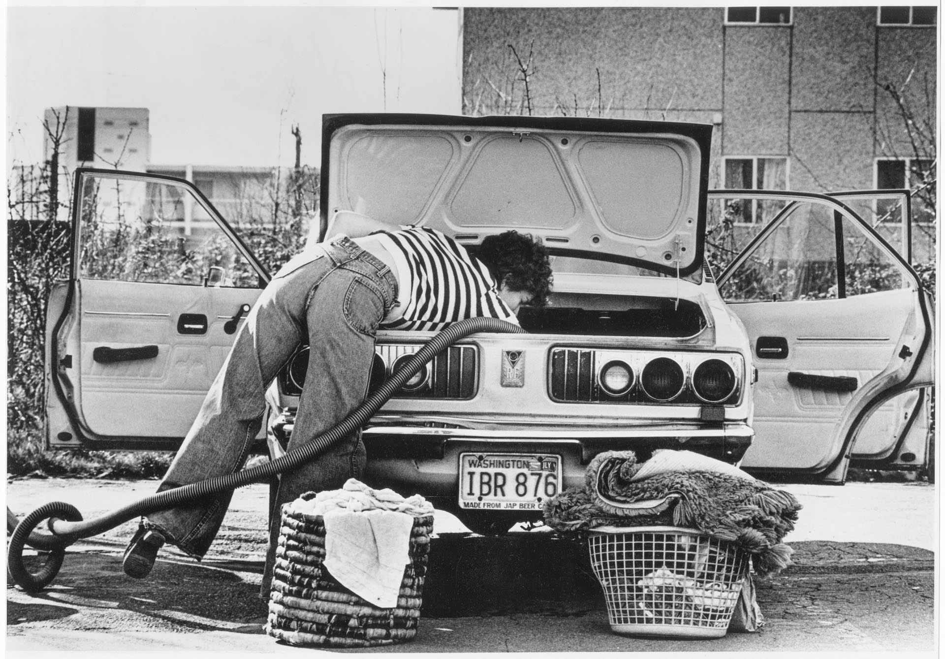 Image of Laurie Zagar vacuuming her car at a car wash, Seattle, March 20, 1980