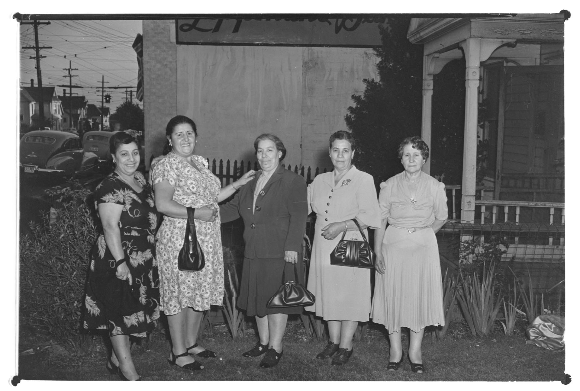 Image of Five women posing in front of a house, circa 1950