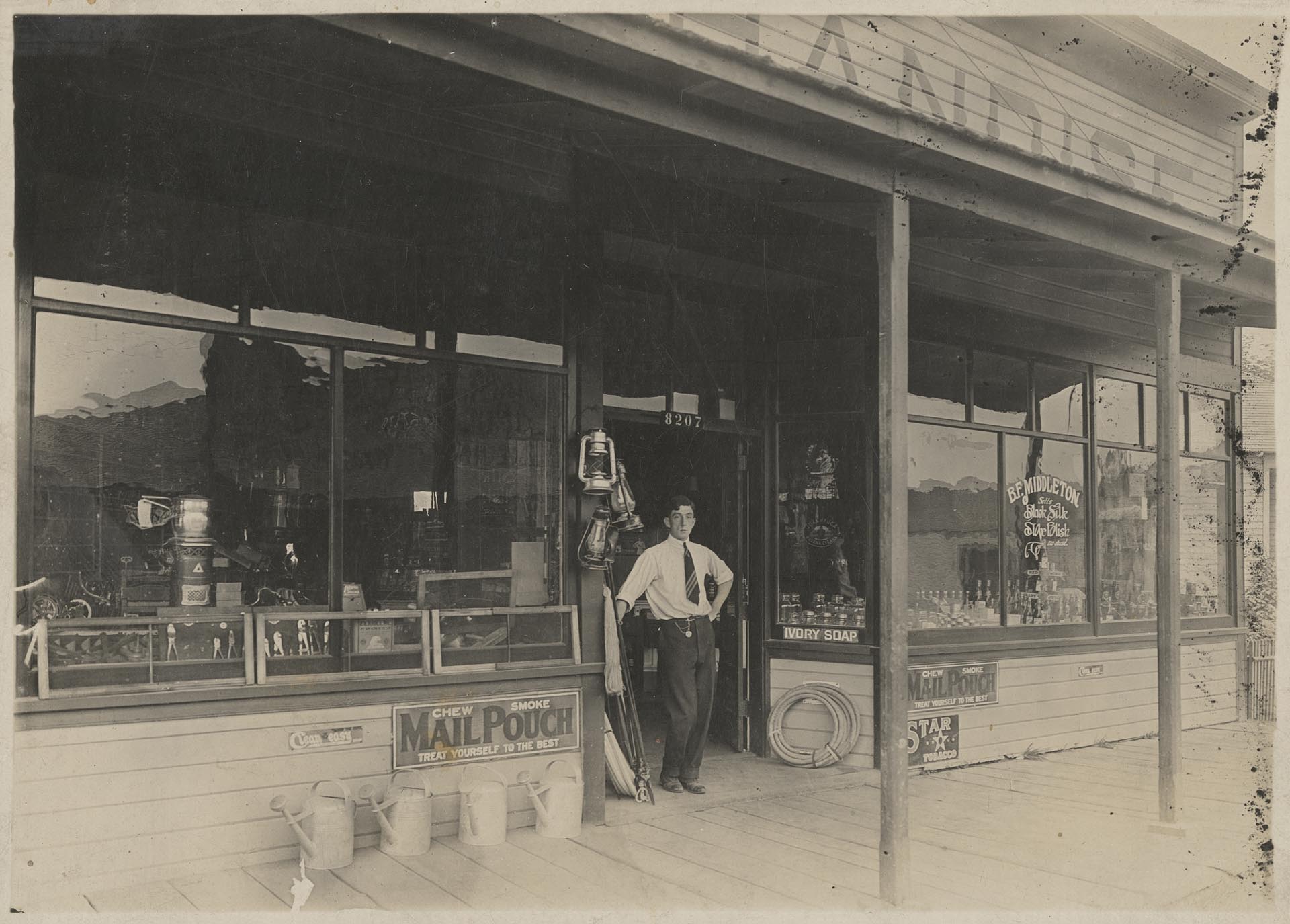 Image of Merl Middleton at front door of Middleton Grocery, Seattle, circa 1910