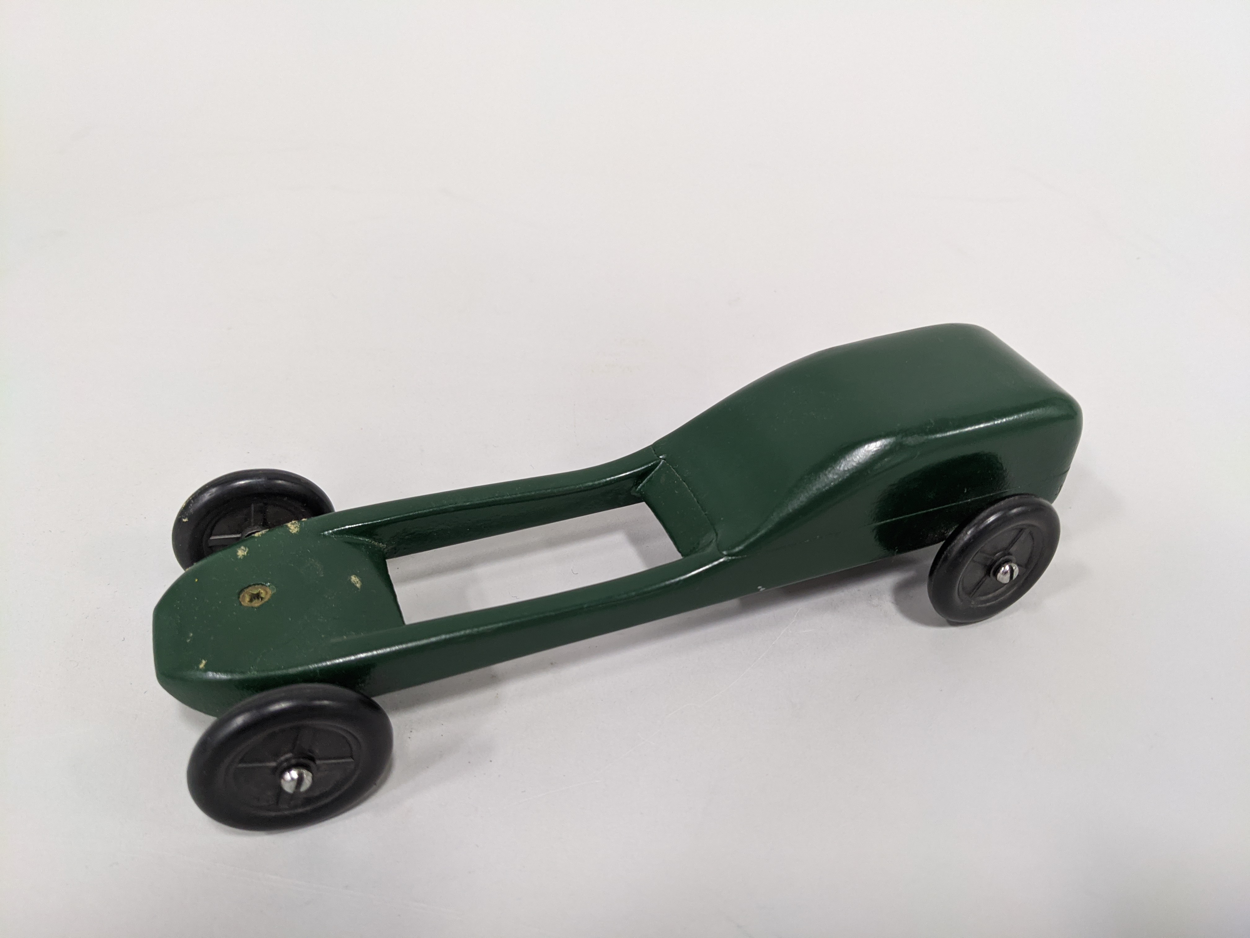 Image of Sleek and sporty green pinewood derby car, one of four, made by Jim Smith, ca. 1995-2010
