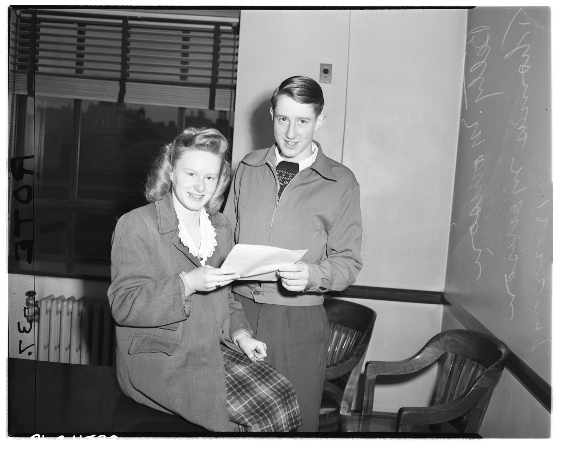 Image of Betty Morrison and Thomas Morrison holding their naturalization papers, December 22, 1947