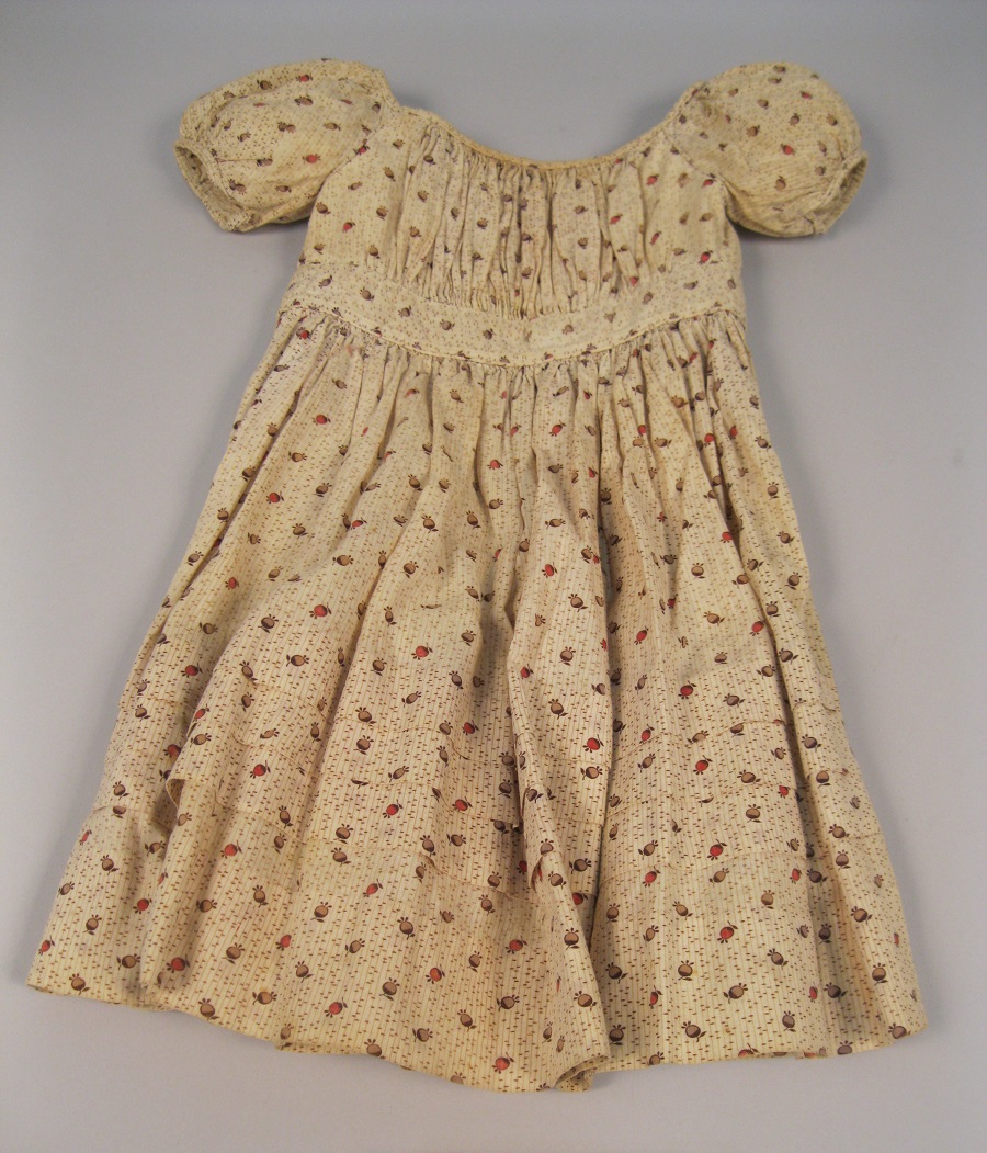 Image of Child's dress with brown and red berry pattern, ca. 1850