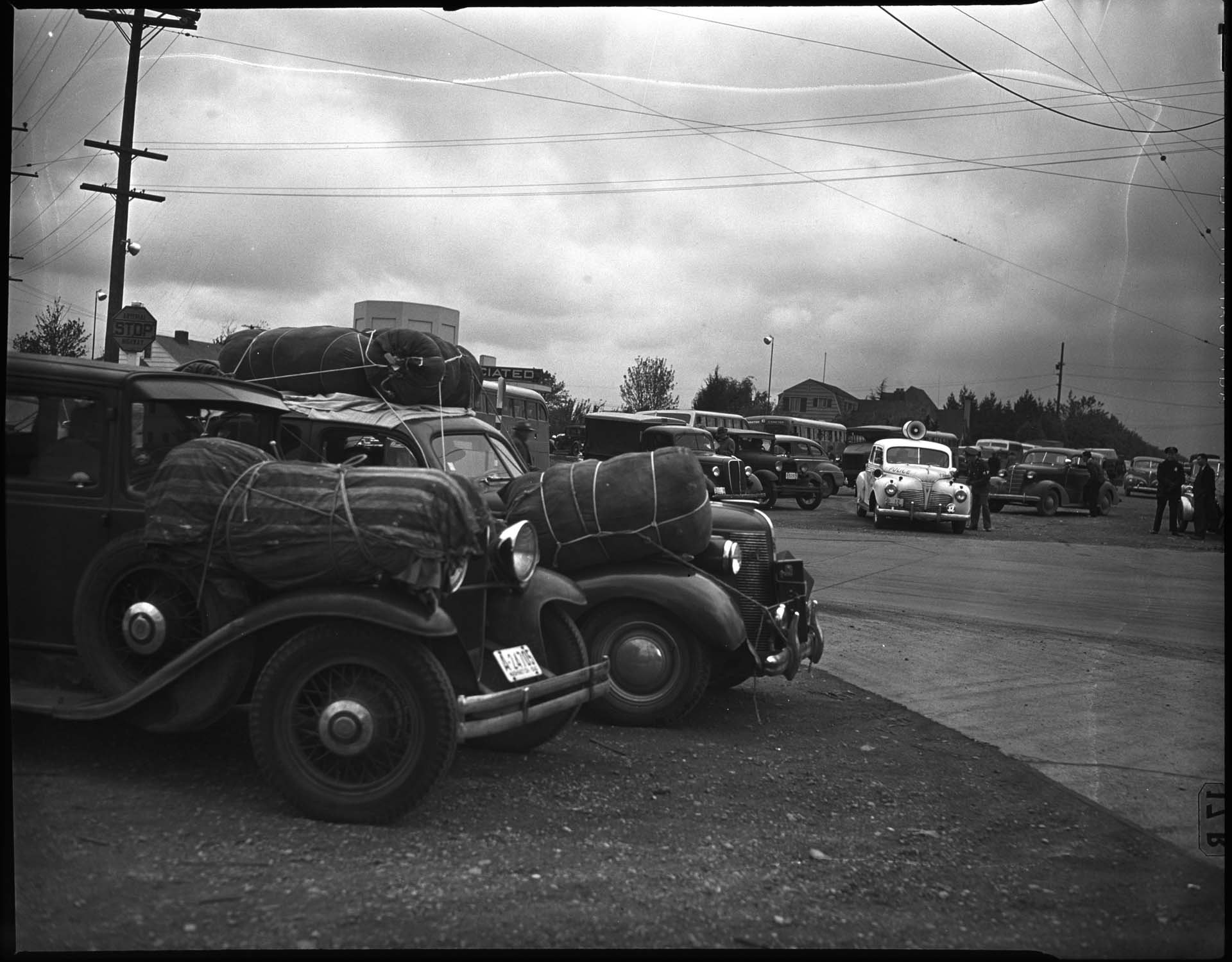 Image of Cars packed with belongings during forced removal of Japanese Americans,  Bainbridge Island, March 1942