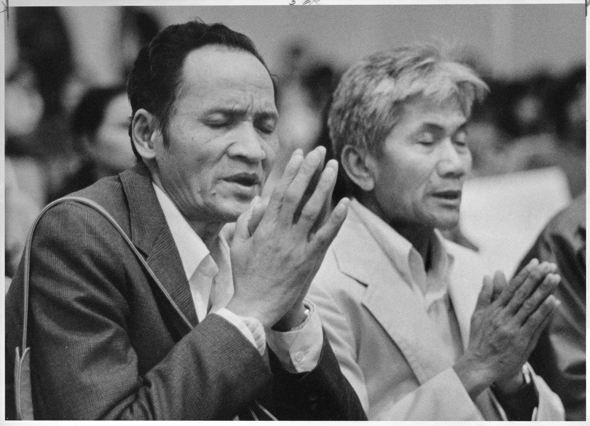 Image of Hay Srey and Voeuk Soth praying for fellow Cambodians, Seattle, January 6, 1985