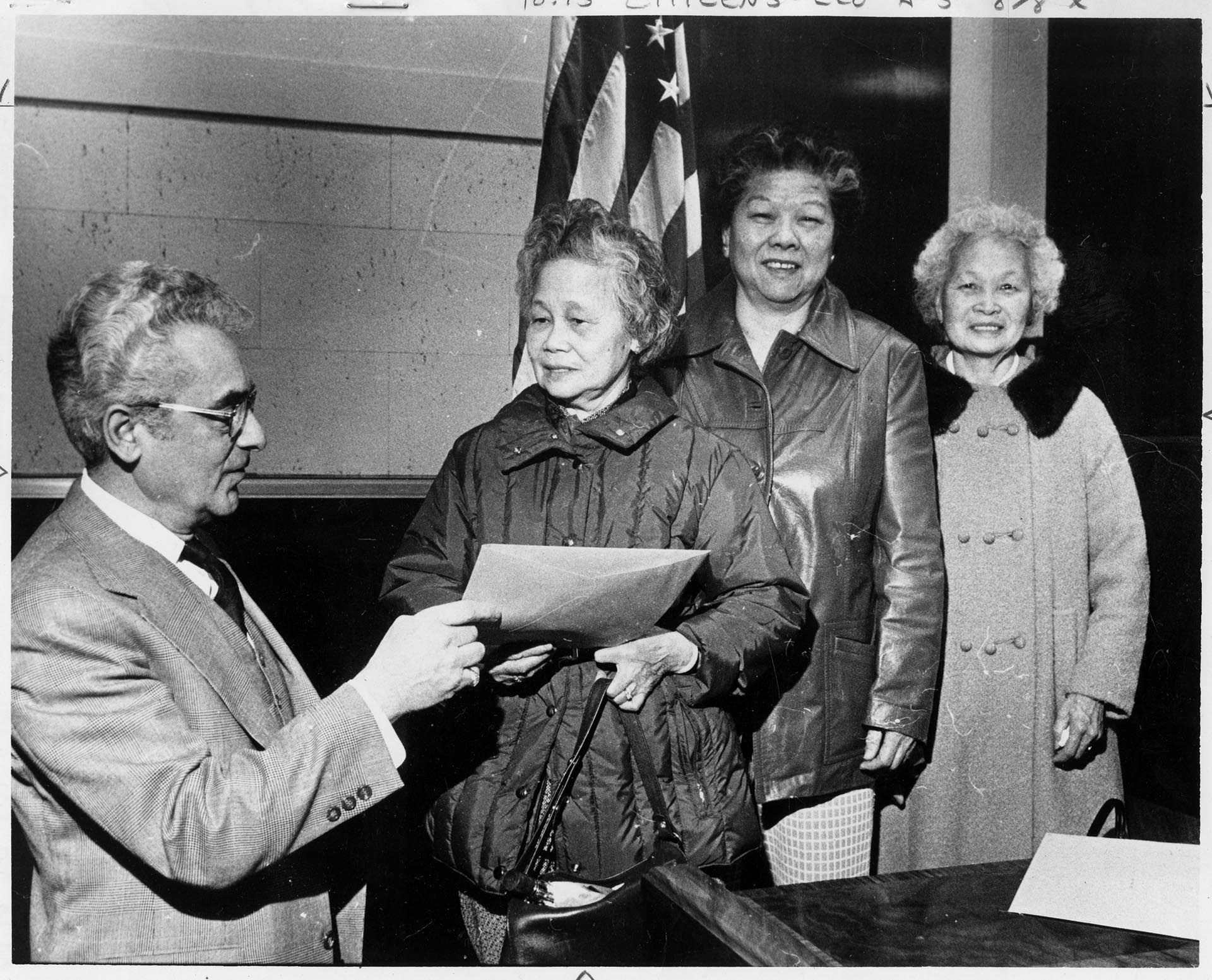 Image of Three Chinese women receiving citizenship papers, February 10, 1979