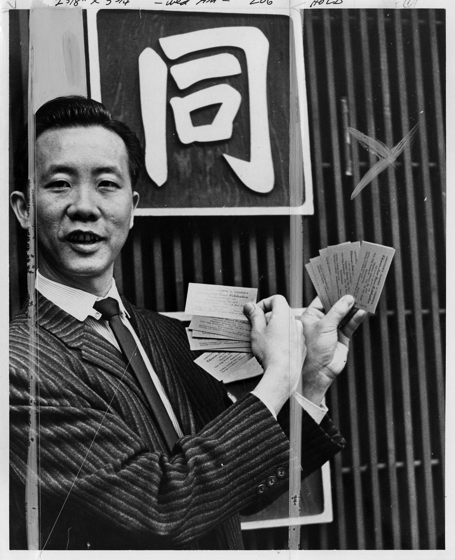 Image of Tommy Quan with Chinese New Year dinner tickets, Seattle, January 1970