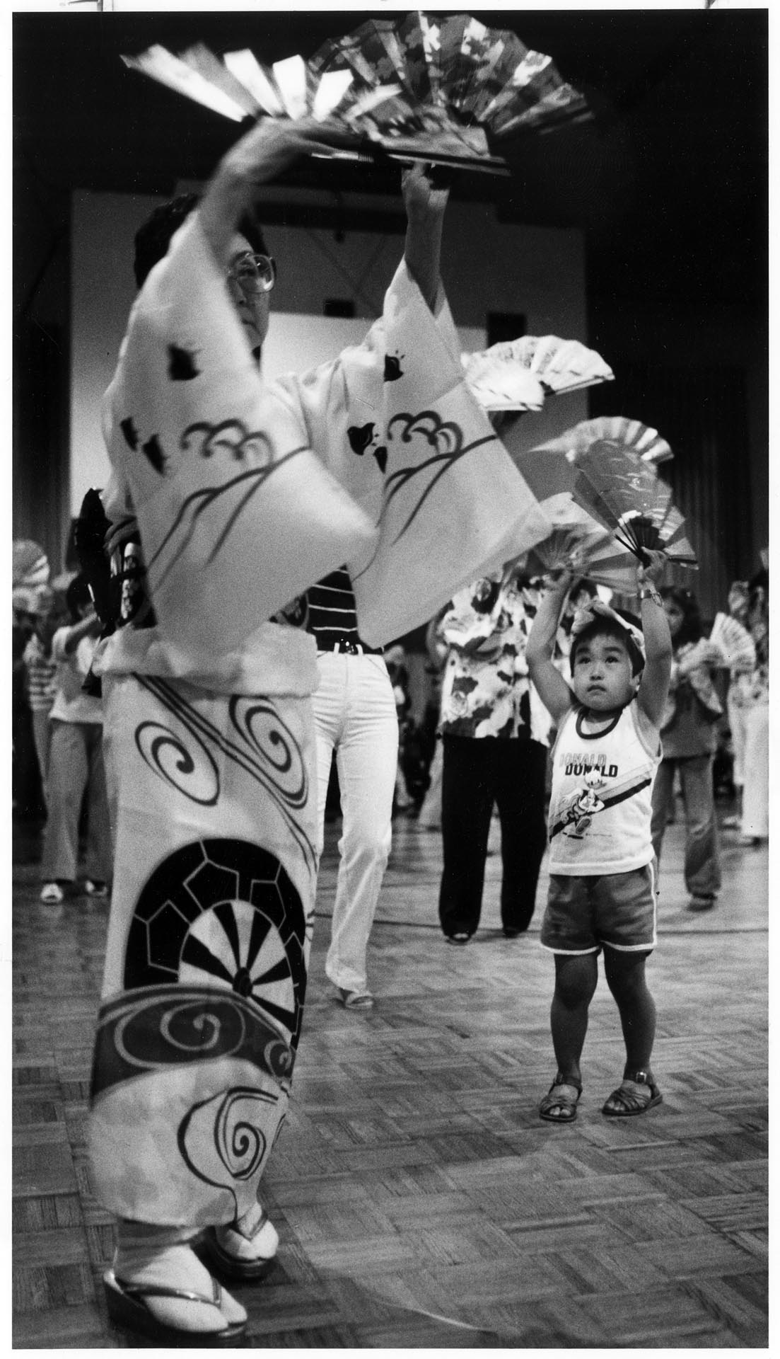 Image of Kiki Hagimori instructs Corey Ojima for Bon Odori, Seattle, July 19, 1983