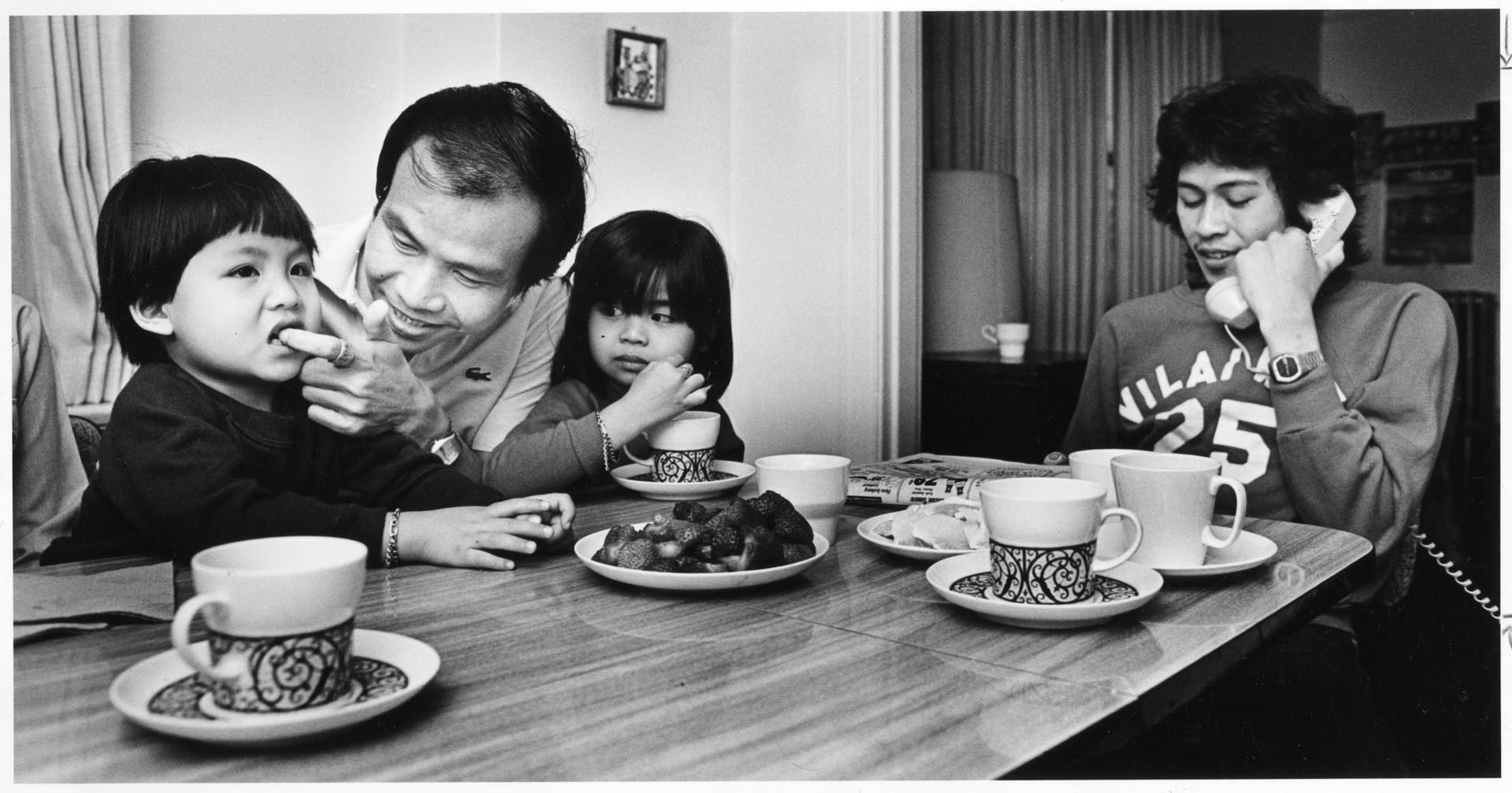 Image of Soukasone and Vilae family at table, Bellevue, July 19, 1981