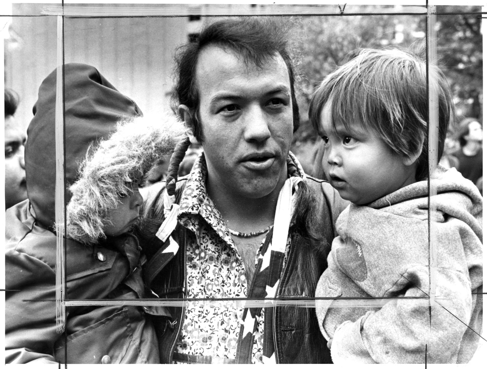 Image of Leroy Mills carrying two children at protest, Seattle, October 14, 1975