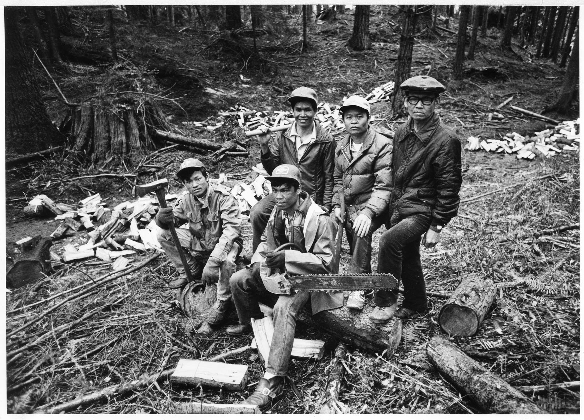 Image of Thongdy family members clearing land for family farm, April 12, 1982
