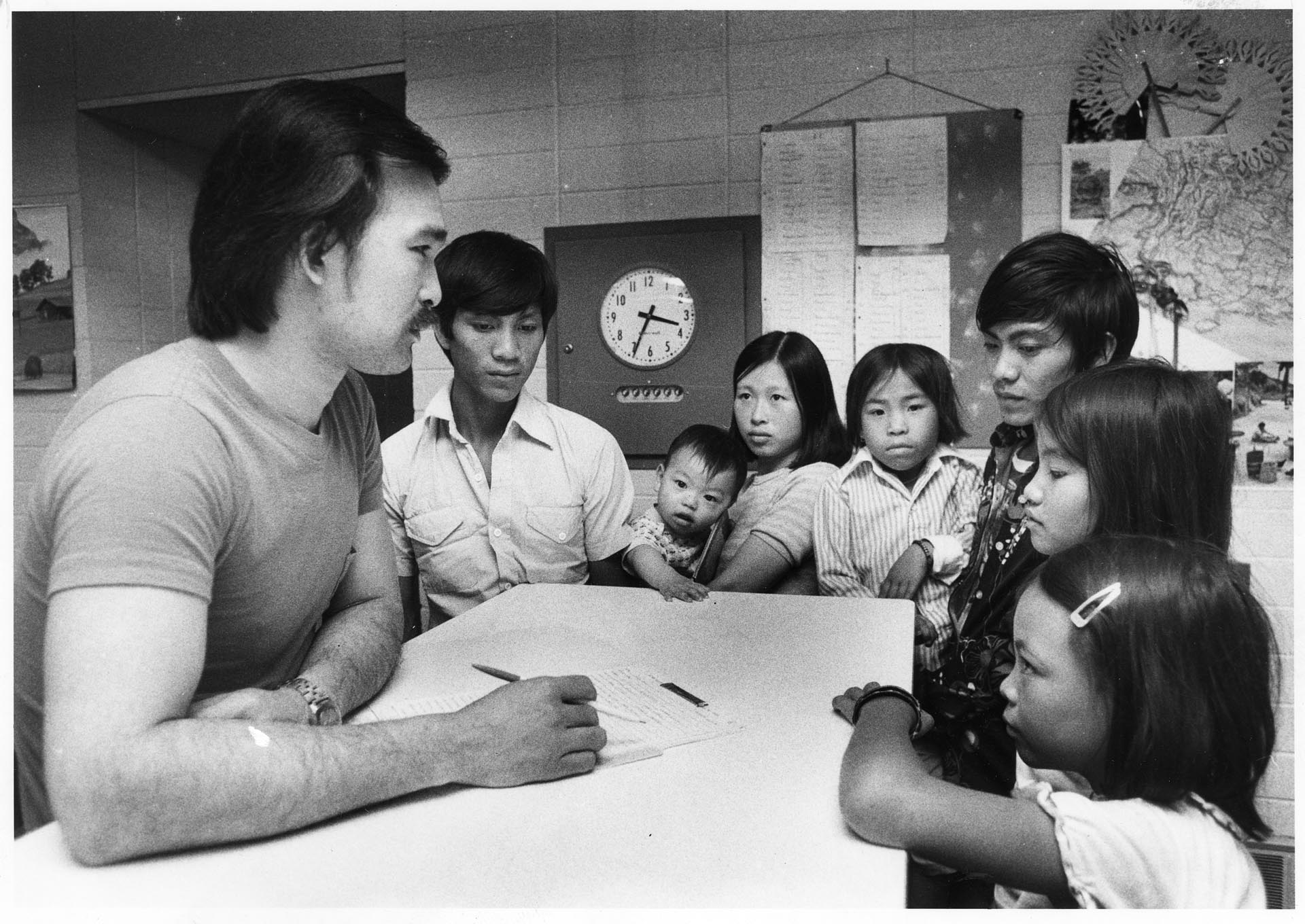 Image of Buntha Nhep counseling Taing family at the Asian Resettlement Center, Bellevue, June 14, 1982