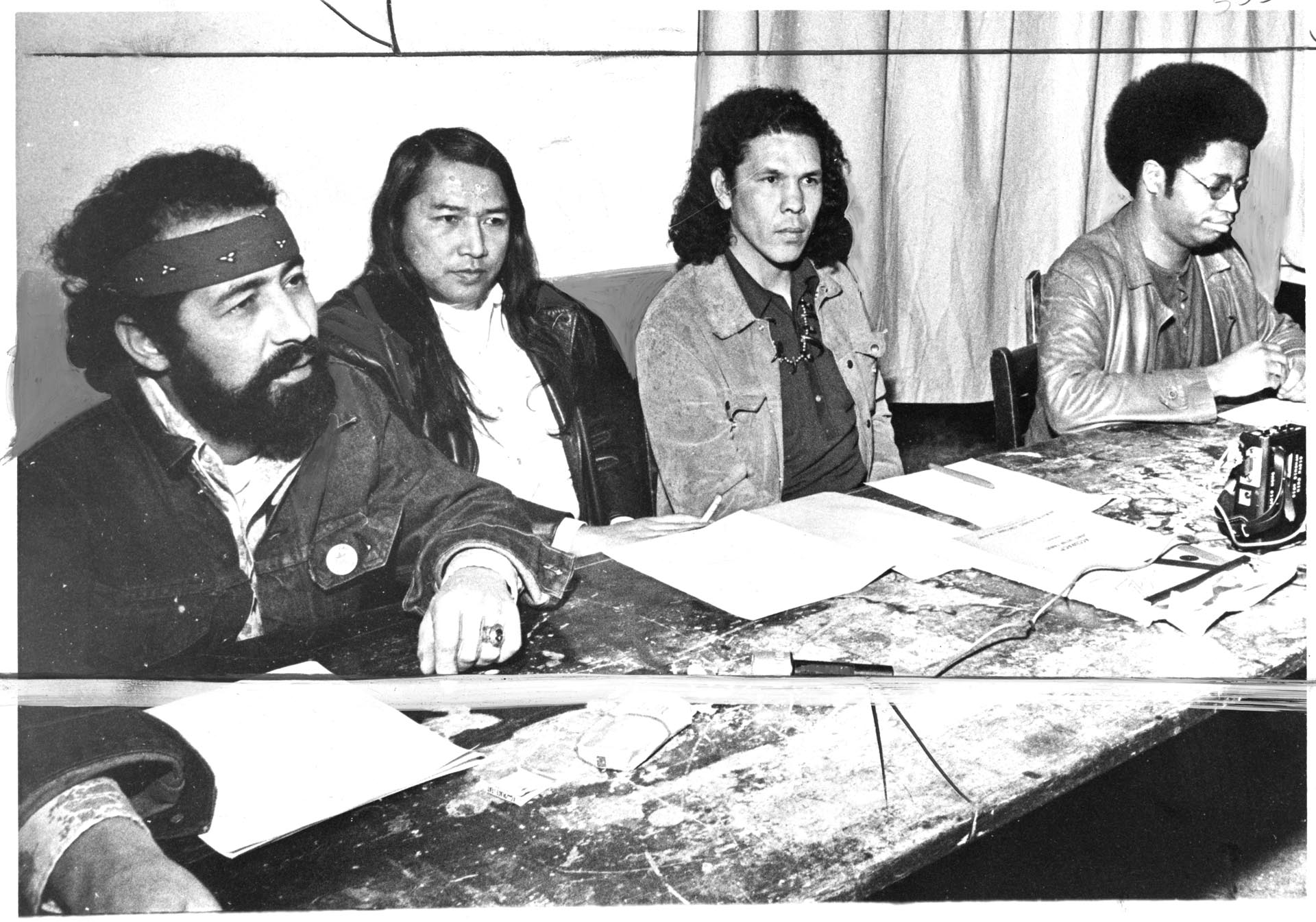 Image of Roberto Maestas, Bernie Whitebear, Jim Robideau, and Larry Gossett speaking at rally, Seattle, February 27, 1974