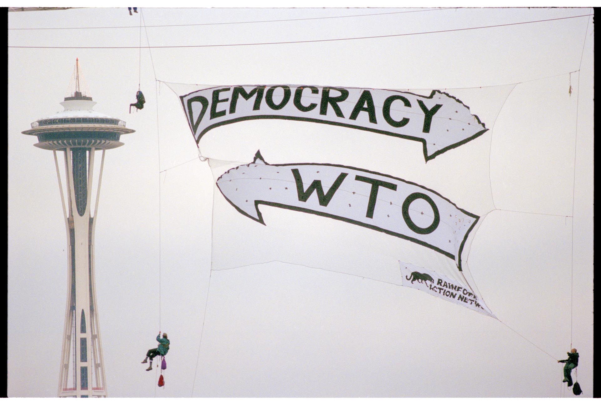Image of Rainforest Action Network WTO protest banner, Seattle, November 29, 1999