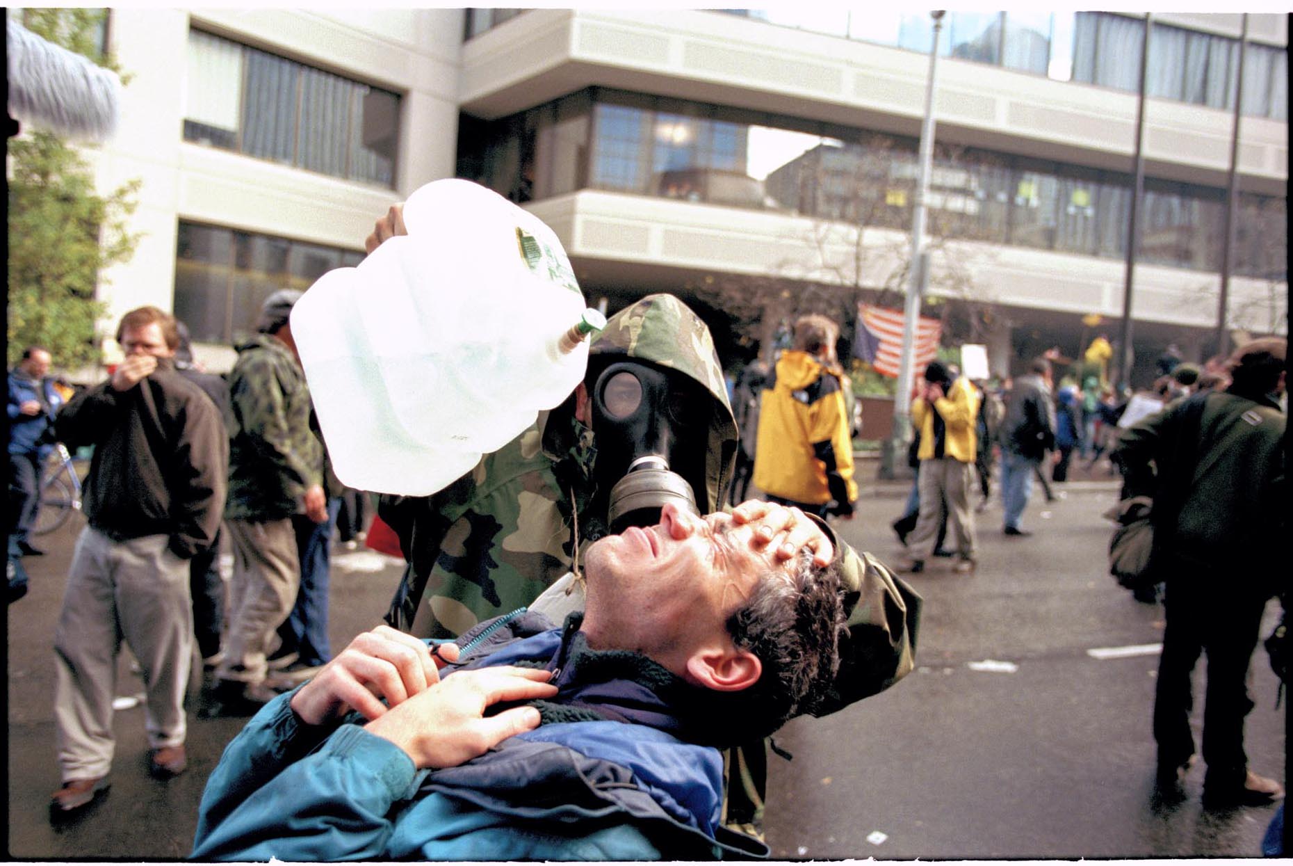 Image of Demonstrators tending to tear gas victim during WTO protest, Seattle, November 30, 1999
