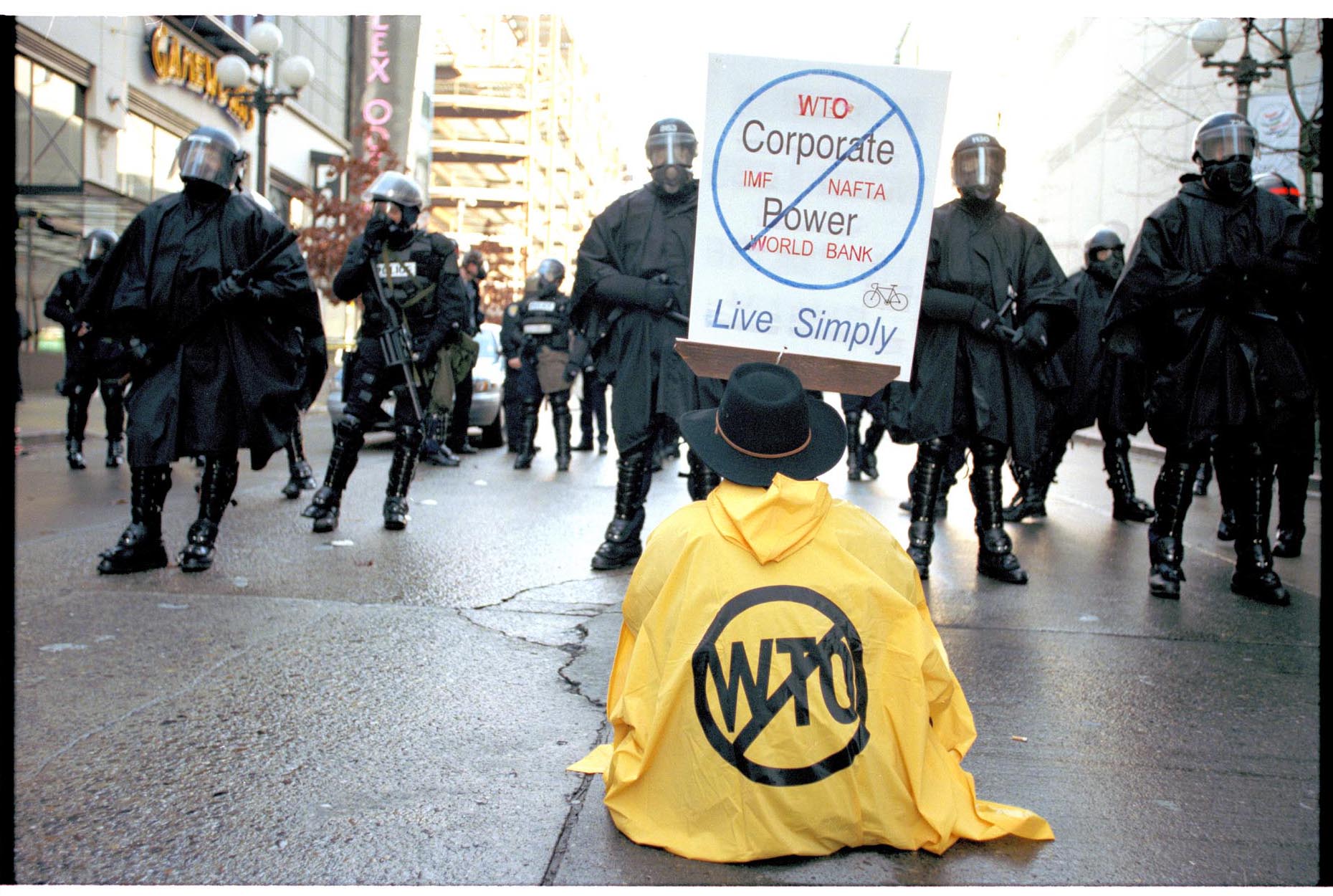 Image of Seated protester facing police line at WTO protest, Seattle, November 30, 1999