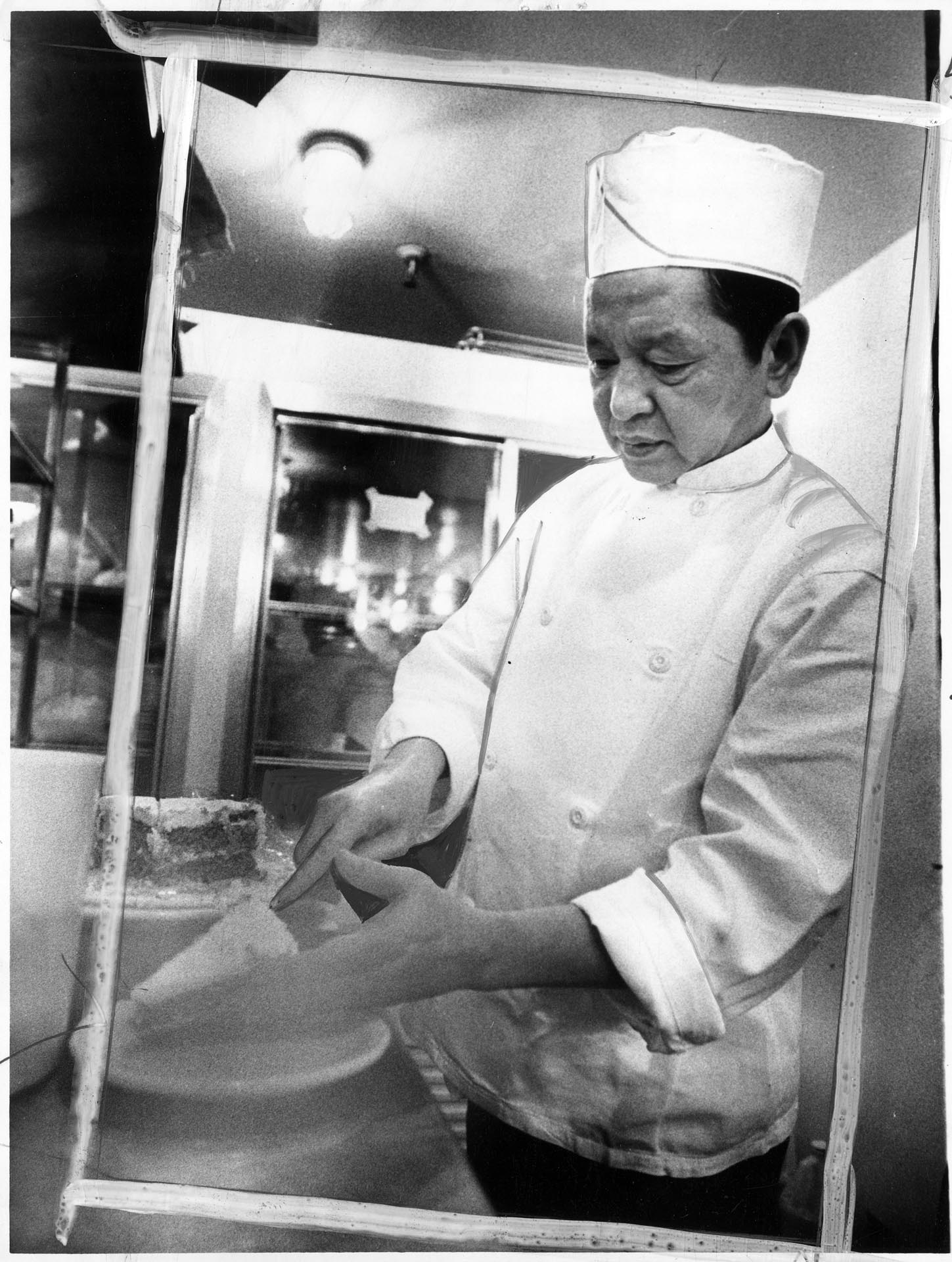 Image of Lan Van Nguyen working in kitchen at City Loan Pavilion, Seattle, February 19, 1976