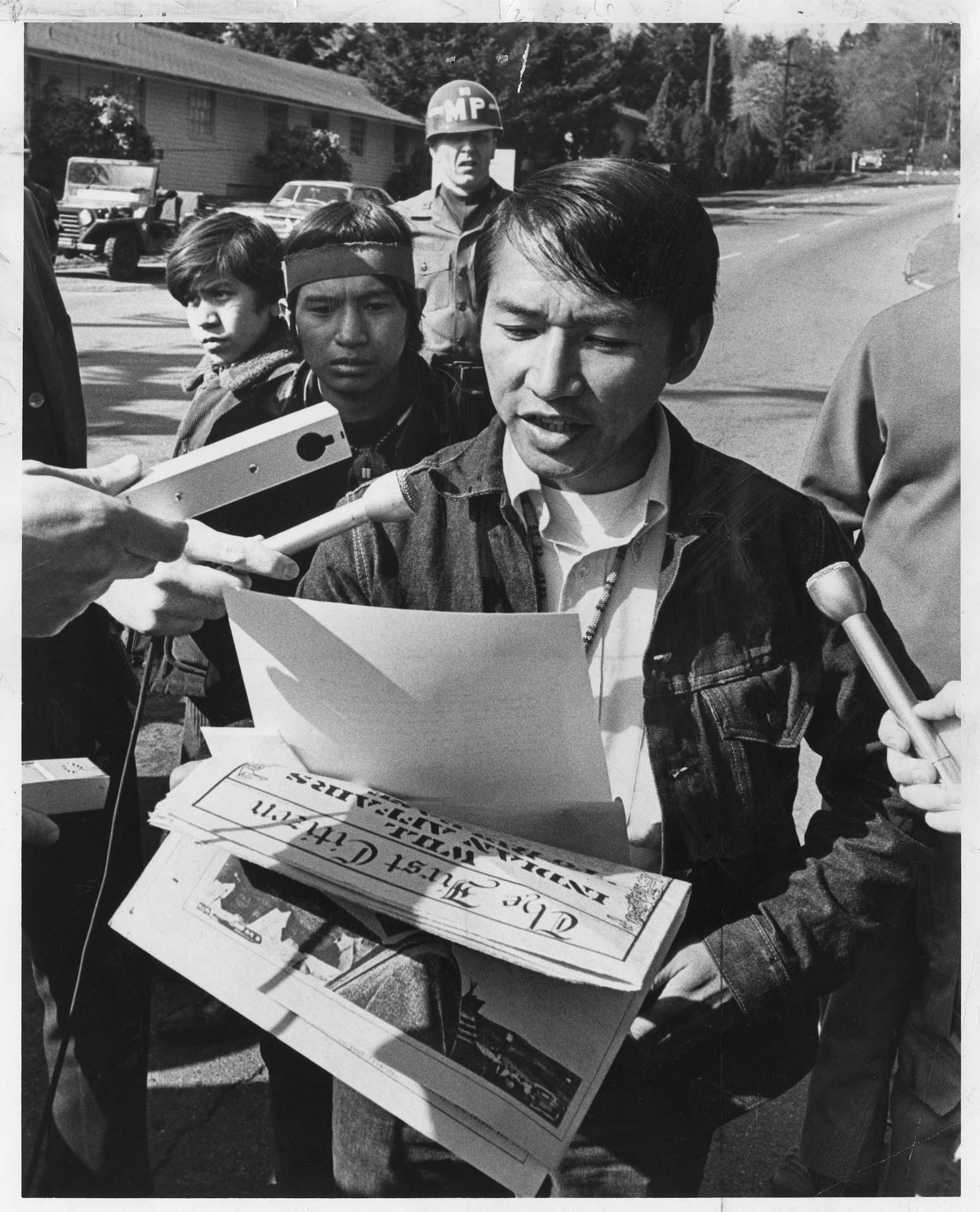 Image of Bernie Whitebear reading proclamation ending protester's encampment at Fort Lawton, Seattle, April 3, 1970