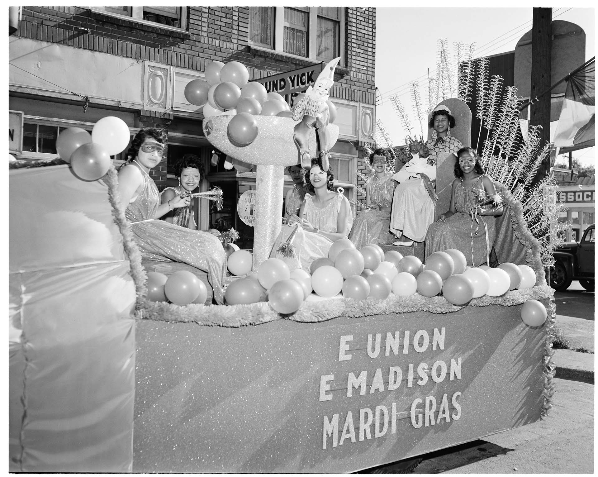 Image of Mardi Gras royalty riding on a parade float, August 5, 1952