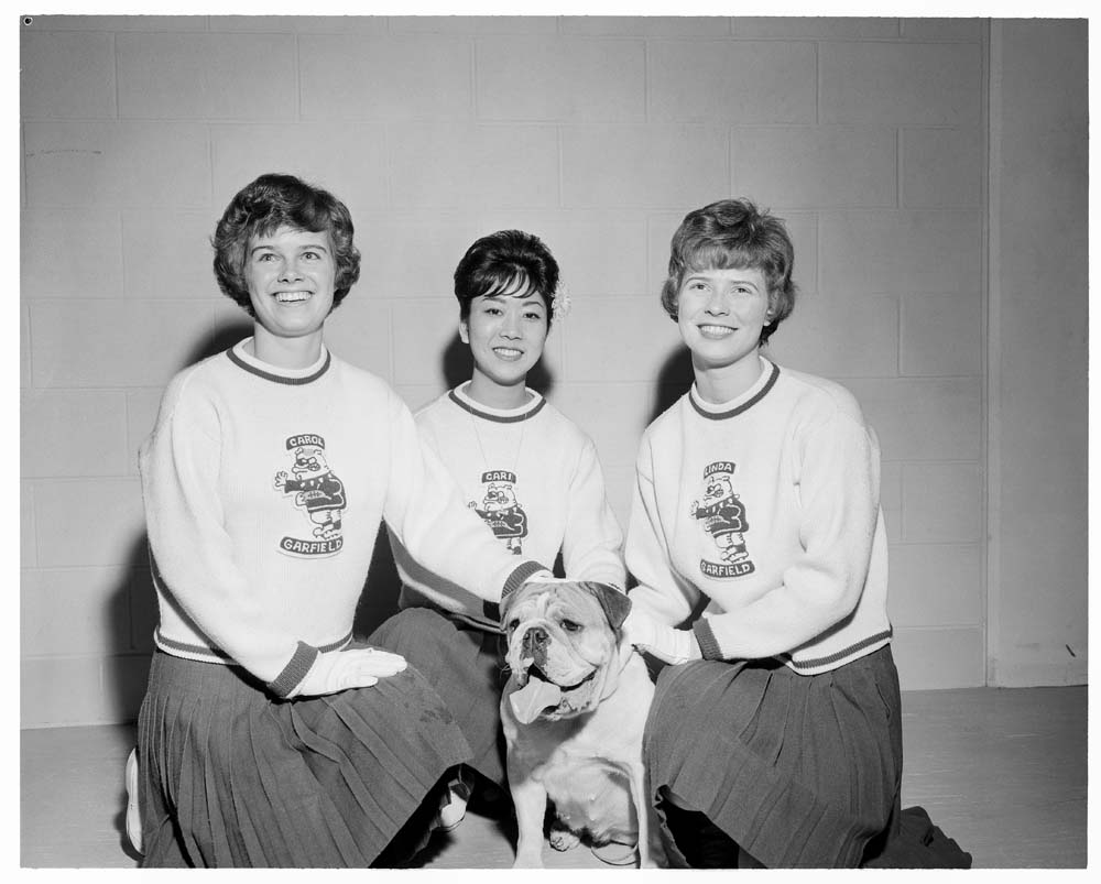 Image of Three Garfield High School cheerleaders and their bulldog mascot, November 20, 1962