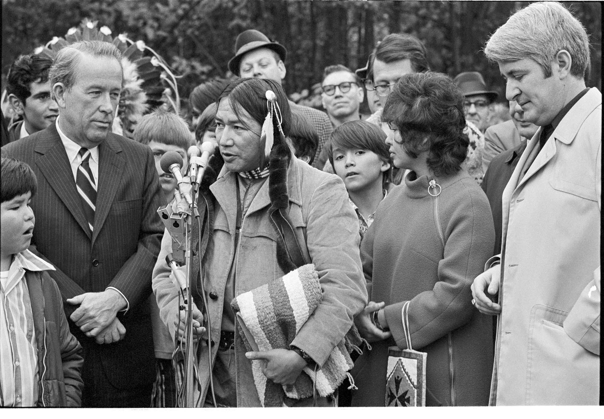 Image of Bernie Whitebear speaking at site dedication for Native cultural center at Fort Lawton, November 14, 1971
