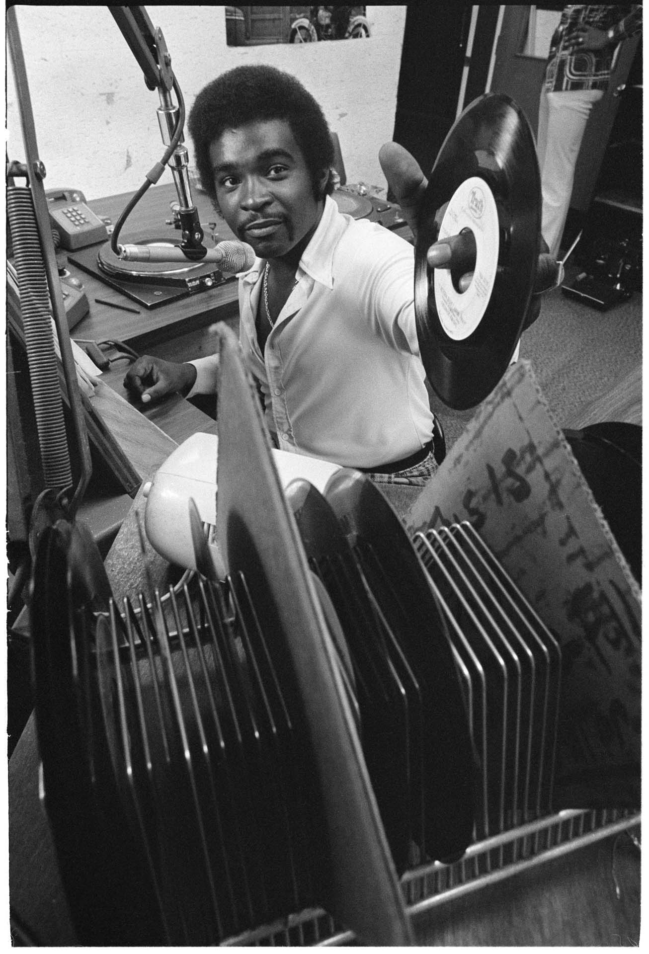 Image of Robert L. Scott in booth at KYAC radio station, Seattle, May 1975
