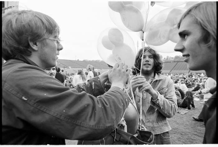 Image of Young men with helium balloons at Jimi Hendrix concert, Seattle, July 26, 1970