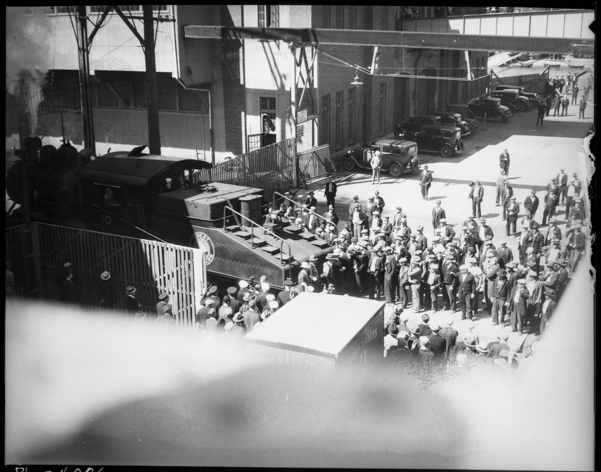 Image of Striking longshoremen with locomotive leaving Smith Cove, Seattle, July 19, 1934