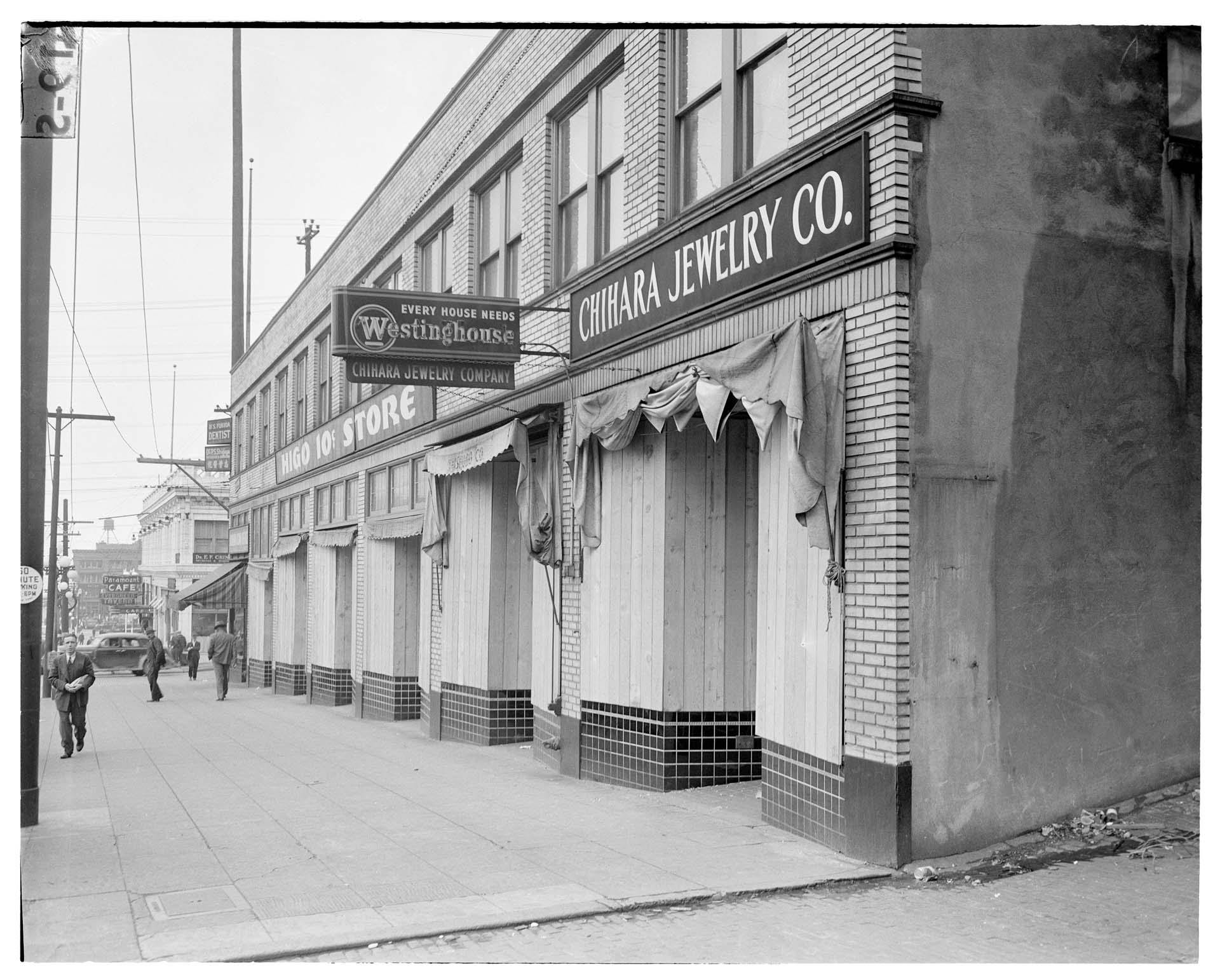 Image of Boarded up window displays on Jackson Street after forced removal of Japanese Americans, Seattle, 1942