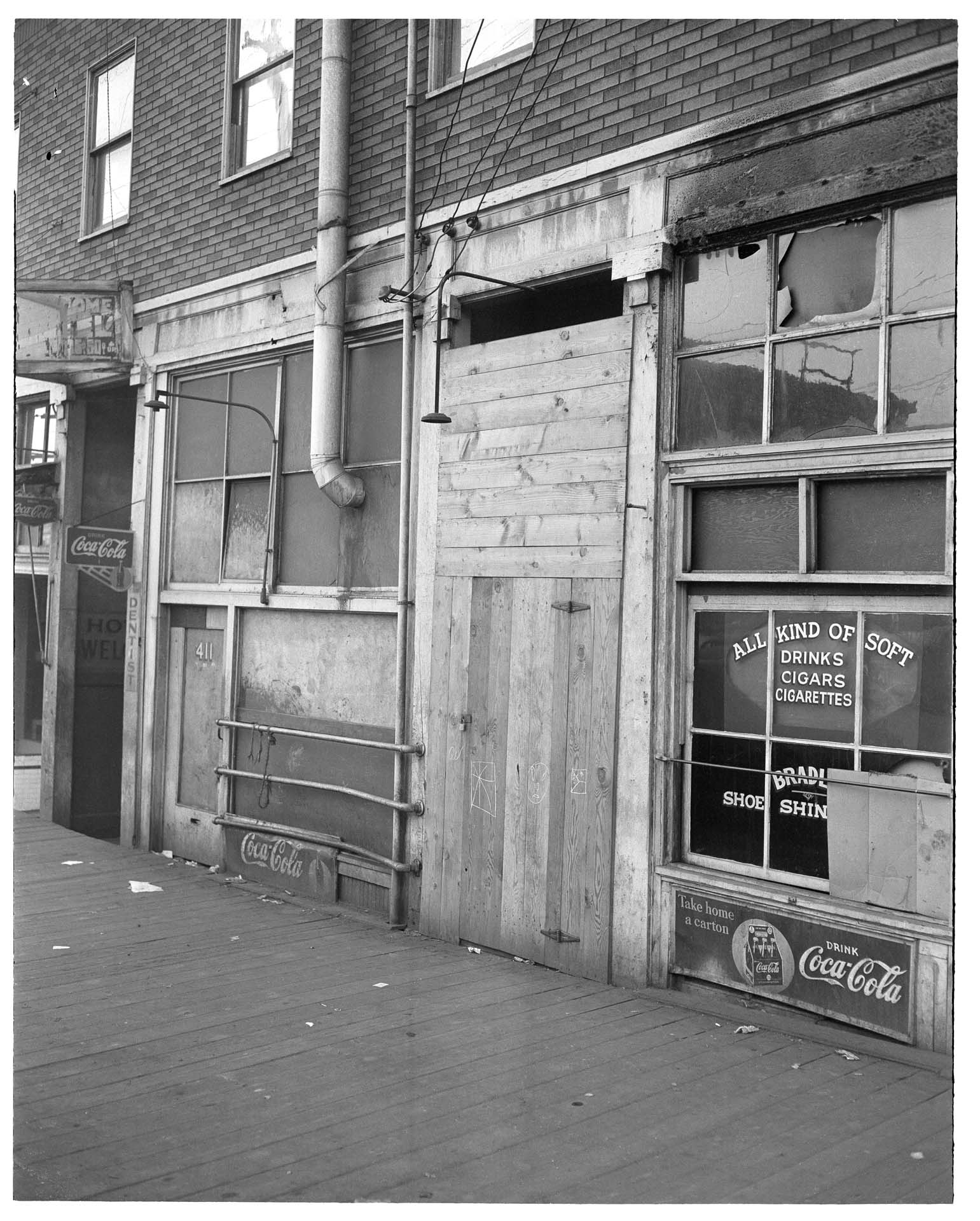 Image of Boarded up storefronts in Chinatown - International District after forced removal of Japanese Americans, Seattle, June 1942