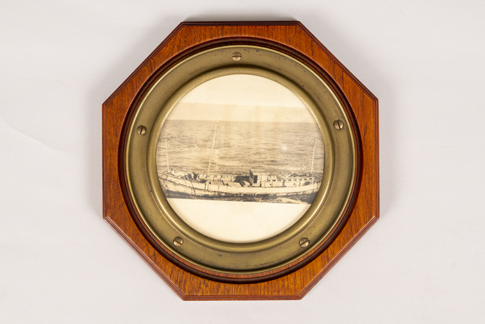 Image of Porthole salvaged from the Ryo Yei Maru and featuring a photograph of the vessel, 1921