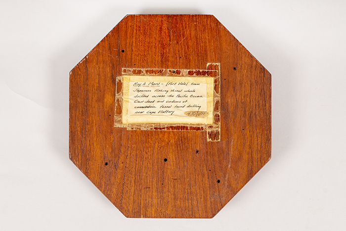 Image of Porthole salvaged from the Ryo Yei Maru and featuring a photograph of the vessel, 1921