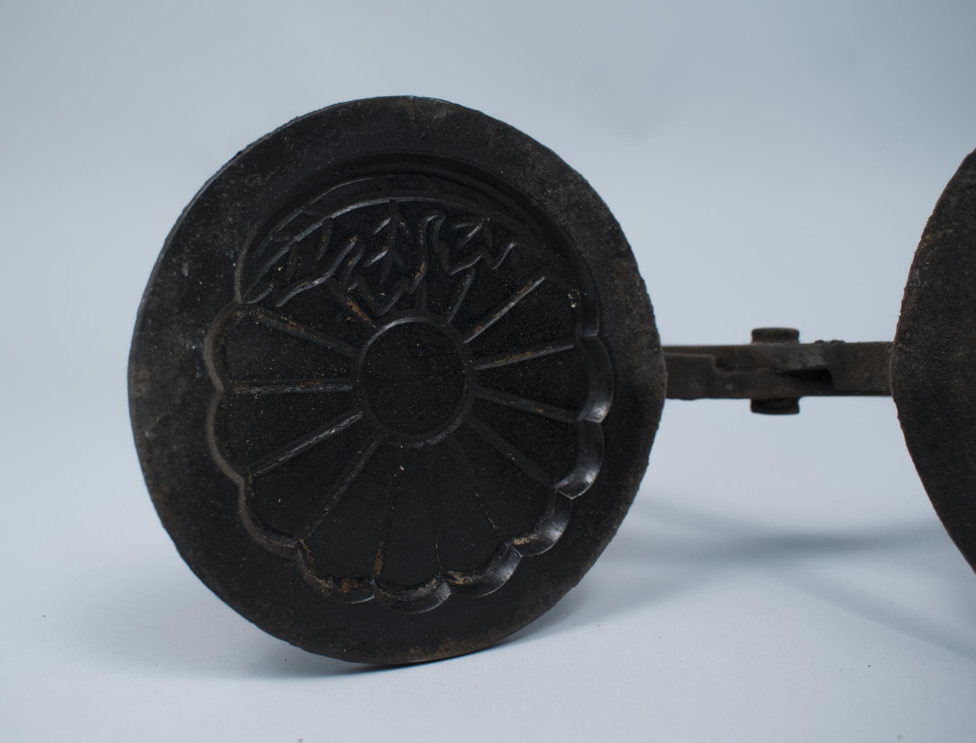 Image of Iron used for shaping senbei, used at the Sagamiya Confectionary Co., ca. 1910
