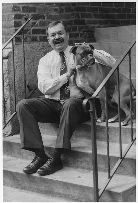 Image of Charlie Brydon and his dog sitting on steps outside his office, Seattle, June 23, 1993
