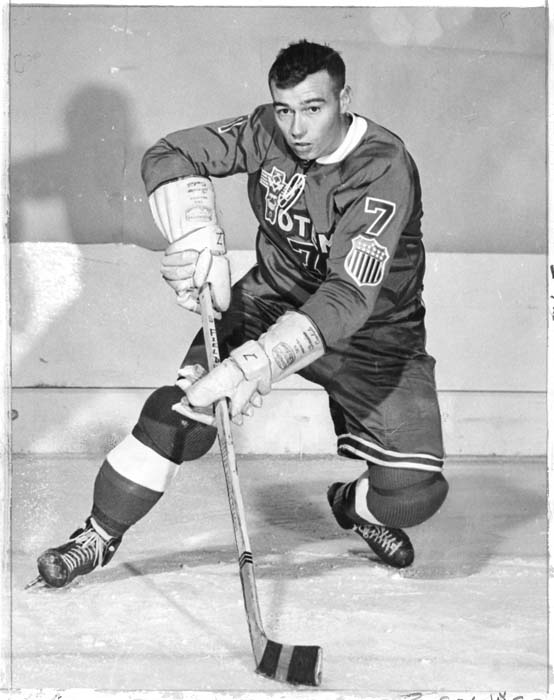 Image of Guyle Fielder posing on ice in hockey uniform, Seattle, 1958