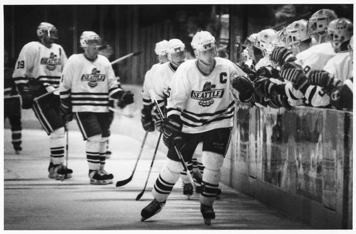 Image of Seattle Thunderbirds line up of high fives across the bench, Seattle, March 6, 1994