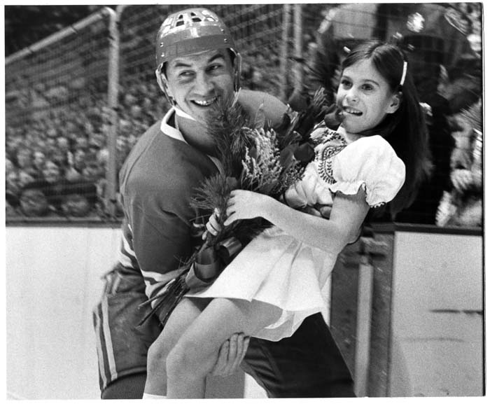 Image of Victor Kuzkin carrying Annette Daggett before Totems-USSR hockey game, December 25, 1972