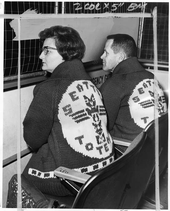 Image of Ida and Leonard Capp in Seattle Totems sweaters at game, Seattle, December 1965
