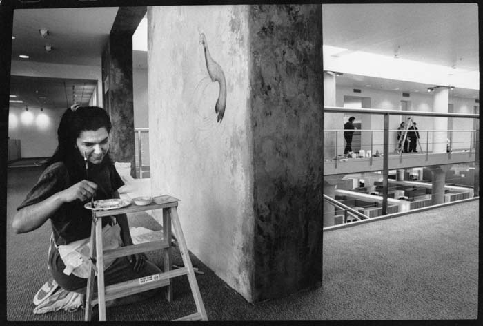Image of Mary Ann Peters painting mural in Port of Seattle building, February 14, 1993