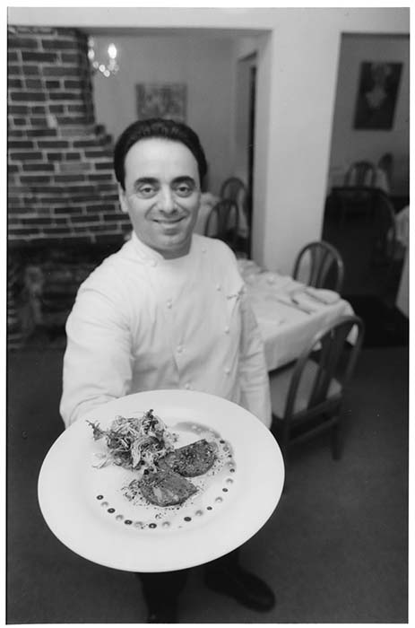 Image of Chef Thierry Rautureau holding a dish of prepared food, Seattle, January 13, 1994