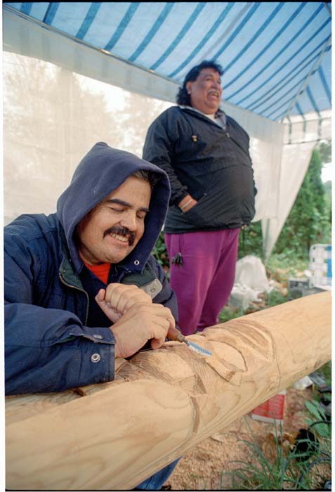 Image of Lummi carvers Verne Johnson Jr. (Tsow-sum) and Ken Cooper working on totem pole, October 21, 1993