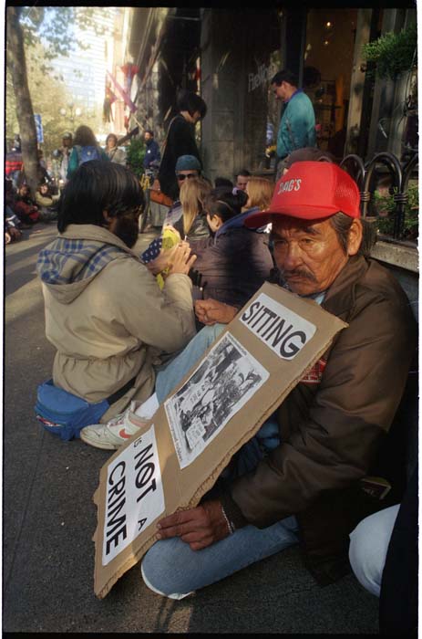 Image of Protesters sitting on sidewalk in defiance of new law, Seattle, November 8, 1993